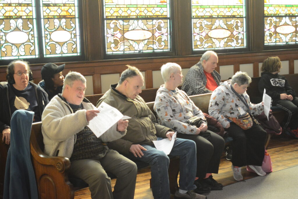 Five members of Sunday Fellowship sit together in a back pew